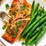 Golden herb crusted sheet pan salmon with roasted green beans recipe.