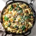 Creamy skillet sausage and spinach pasta recipe with crispy sausage details.