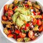 Colorful Southwest pasta salad with creamy lime dressing and fresh avocado garnish