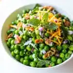 Spring pea salad with mint features a creamy dressing and vibrant fresh ingredients.