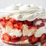Layered strawberry shortcake trifle with creamy filling and fresh berries.