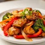 Tender teriyaki chicken stir fry with broccoli and peppers in glossy sauce.