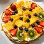 Tropical fruit pizza with citrus glaze on a sugar cookie crust.