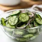 Tangy rice vinegar cucumber salad with fresh dill and red onion slices