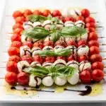 Patriotic Caprese flag skewers appetizer with tomatoes mozzarella and basil.