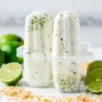 Creamy coconut lime popsicles with glossy icy texture and zest