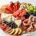Patriotic Fourth of July cheeseboard with red white and blue foods