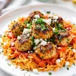 Greek chicken meatballs with creamy lemon orzo in a close up food photo.