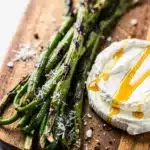 Grilled garlic scapes with lemon glaze and Parmesan cheese