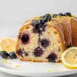 Moist lemon blueberry pound cake slice drizzled with glaze.