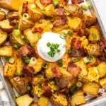 Crispy loaded breakfast potatoes topped with cheese bacon and green onions