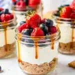 No bake cheesecake jars with strawberries blueberries and salted caramel
