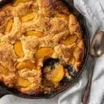 Peach cobbler with canned peaches golden bubbly crust closeup