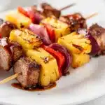 Grilled pork skewers with pineapple glazed in a sticky barbecue sauce.