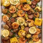 Sheet pan shrimp boil with sausage, corn, potatoes, and Old Bay seasoning.