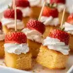 Strawberry shortcake kabobs with pound cake and whipped cream on skewers