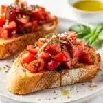 Close-up classic tomato bruschetta on rustic wooden board.