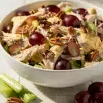 Chicken salad with grapes and pecans in white bowl.
